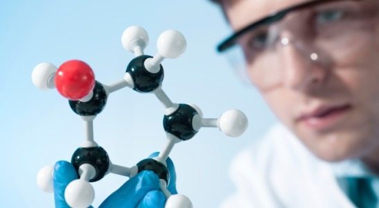man looking at molecular structure model