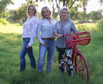 sisters in the field wiht a bike