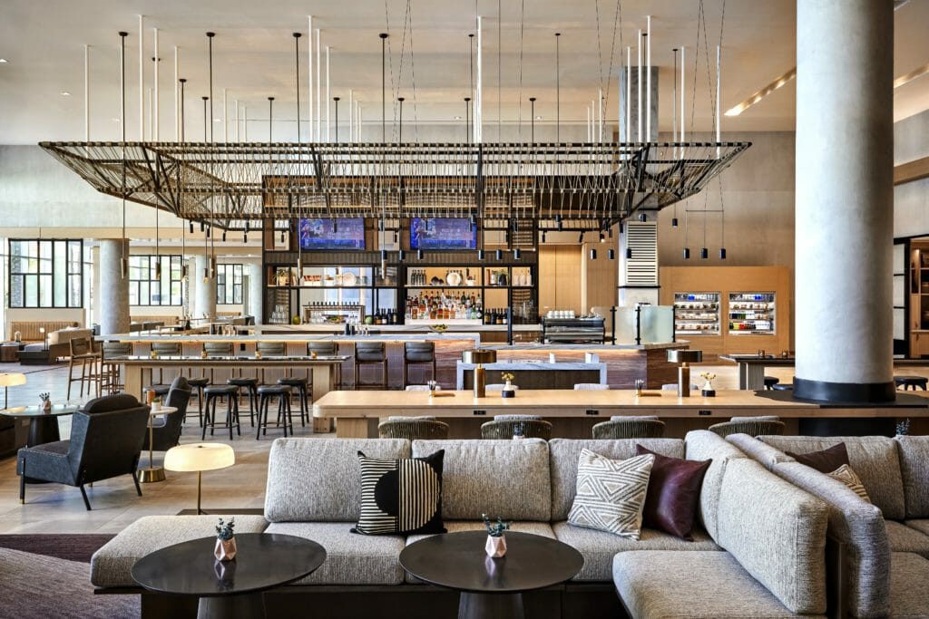 Image of Sheraton Phoenix Downtown central bar in lobby with comfortable couch seating and modern decor.