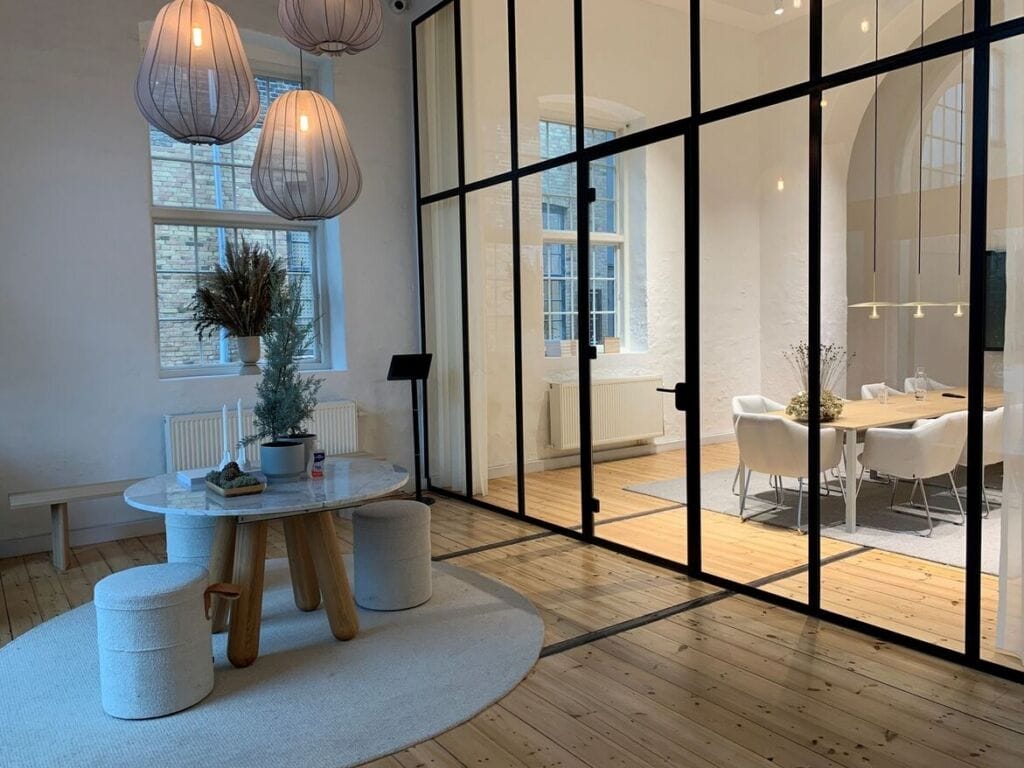 Modern office interior with glass partition wall and conference room.