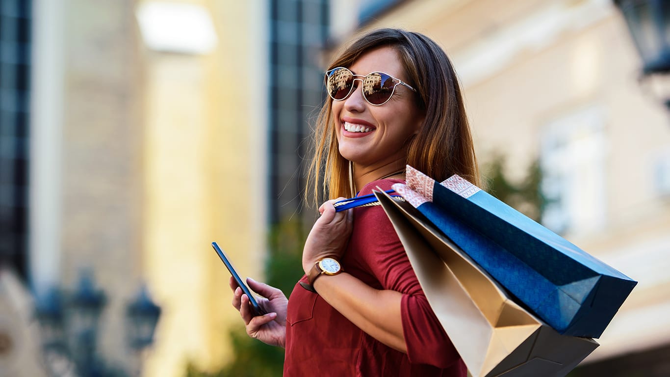 Modern young woman enjoys shopping.