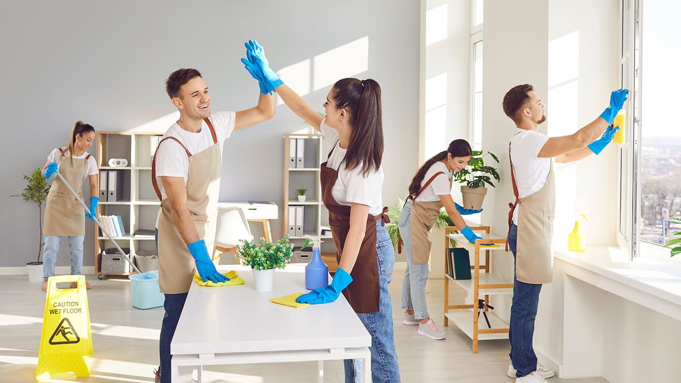 Cleaner happy group high five, finish working, professional janitor service busy completing cleaning tasks at home, office. Young people employed to take care of room, company maintaining washing.