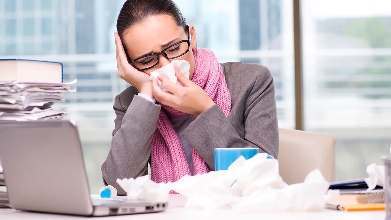 Young businesswoman sick in the office.
