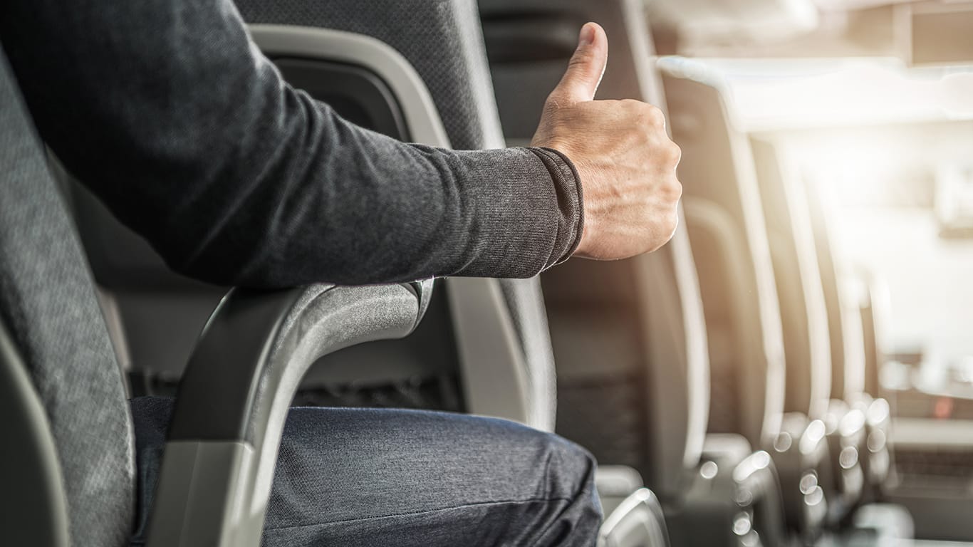 Public Transportation Passenger Showing His Thumb Up. Caucasian Men Seating Inside Intercity Coach Bus. Transportation Industry Theme.