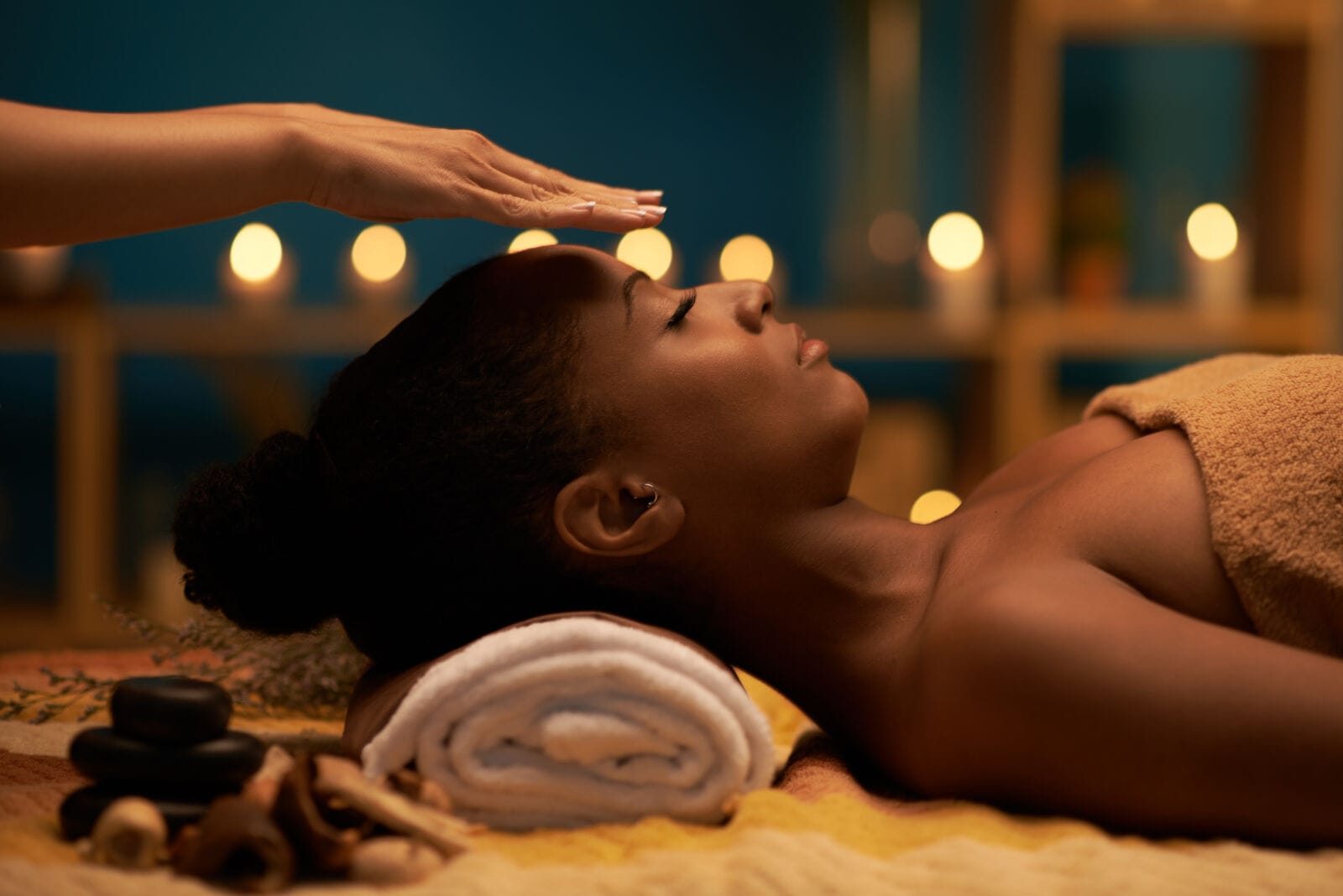 Therapist holding hands above head of the patient to transfer energy.